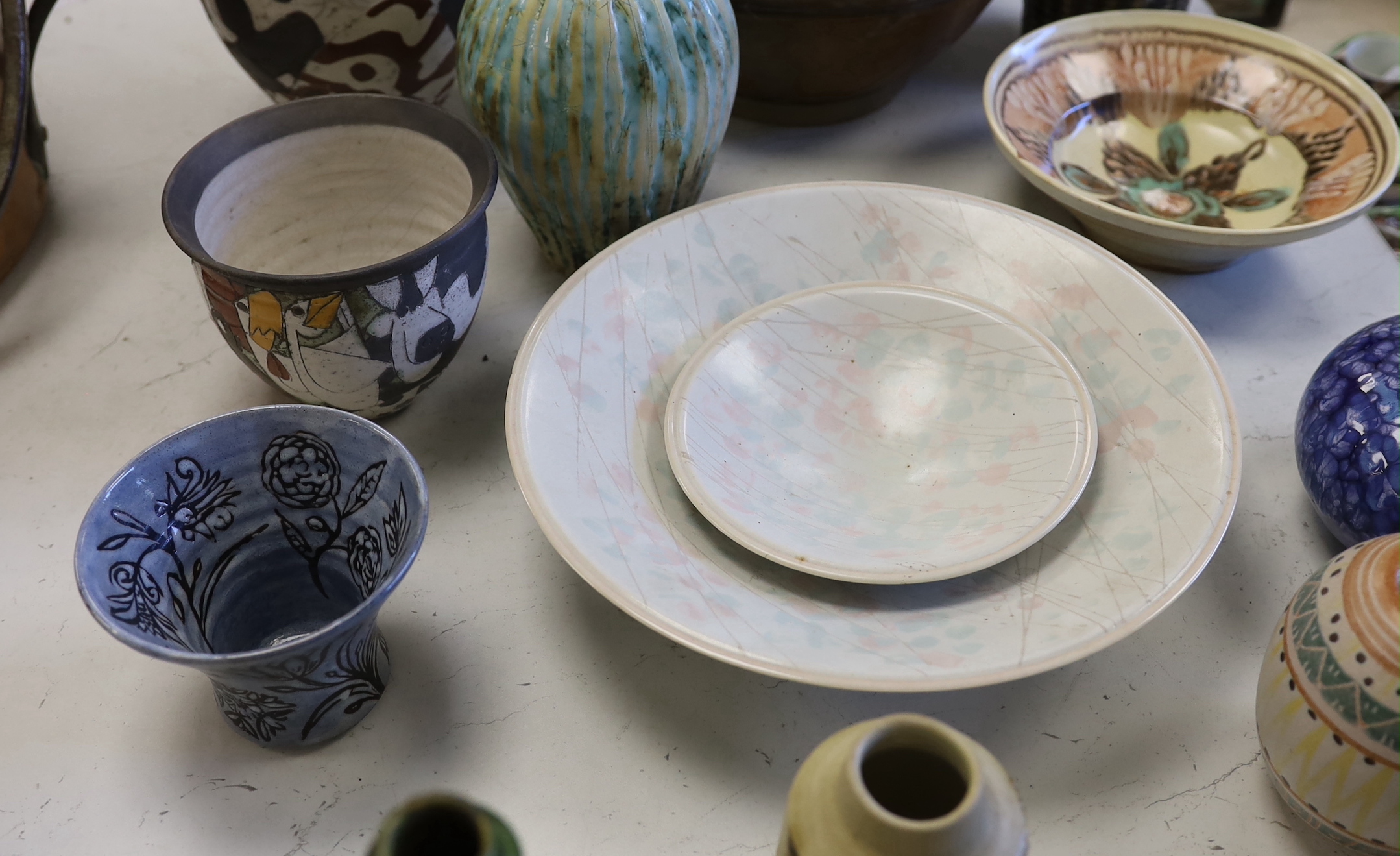 A collection of studio pottery including a Kenneth Annat Bemersyde Scottish vase, two graduated bowls and a jardiniere incised with birds, the largest 28cm high